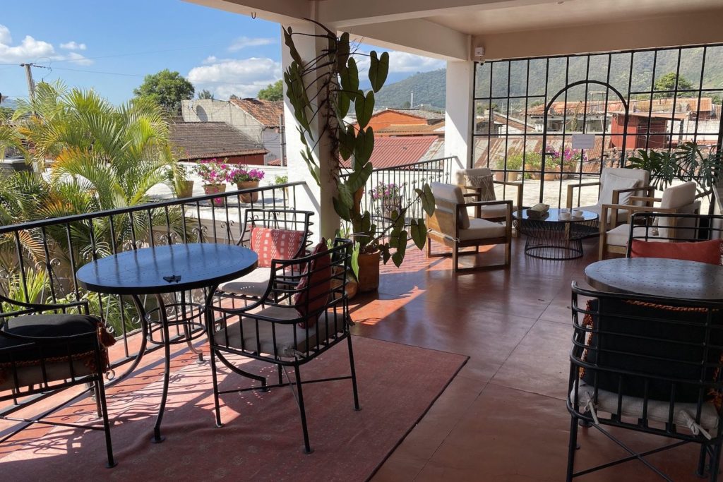 This image shows a sunny, outdoor terrace at Ojala. The hotel turned coworking space is the perfect blend for the traveling digital nomad.