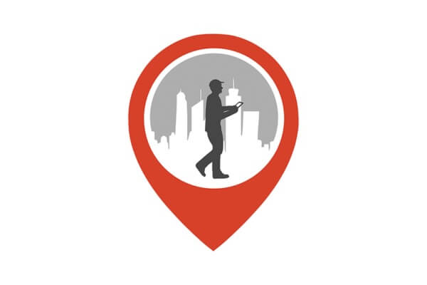 A red map pin icon features a silhouette of a person with a smartphone against a city skyline with tall buildings in the background.